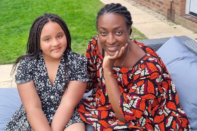Black mum and daughter taking a picture together