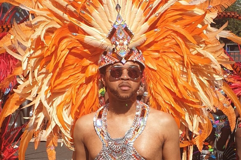 Picture of a black man in a festival outfit